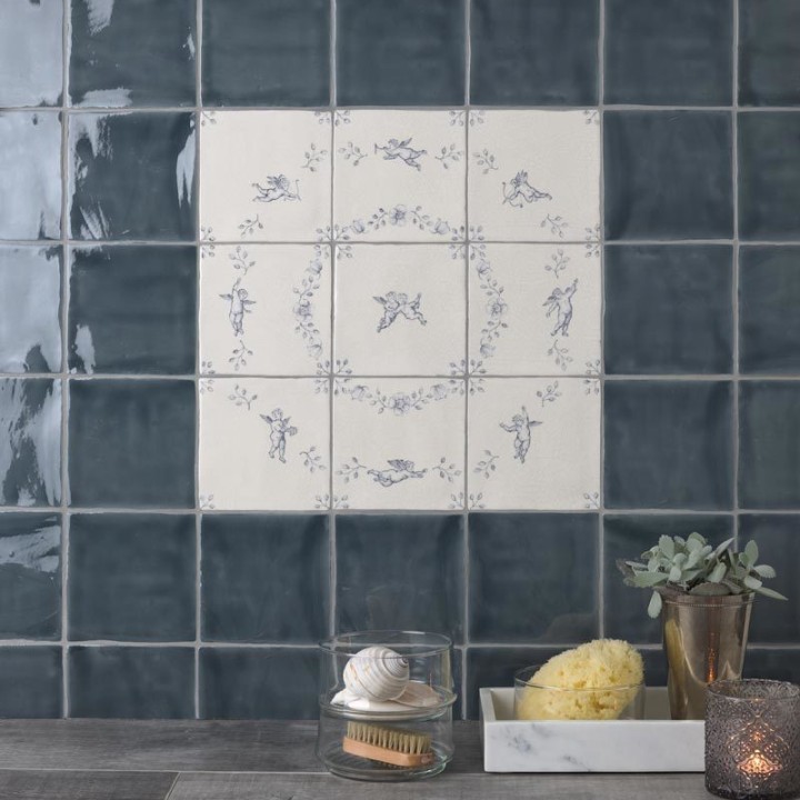 Panel of 9 square tiles with delft illustration of cherups framed with blue square tiles with medium grout a gold vase
