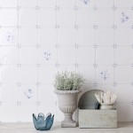 Wall of delft flower square tiles mixed with plain delft tiles in the classic blue style behind home accessories