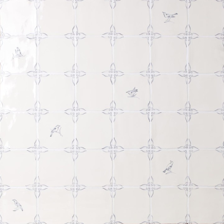 Wall of delft bird square tiles mixed with plain delft tiles in the classic blue style