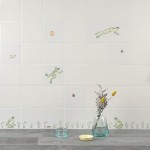 Wall of ivory tiles with hand painted sitting and leaping frogs, pond grasses and insects styled with a grass and glasses