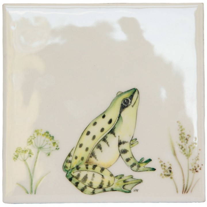Cut out of a green sitting frog ivory tile with grasses