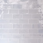 Wall of lustre iridescent white medium metro tile laid in a brick bond tile pattern