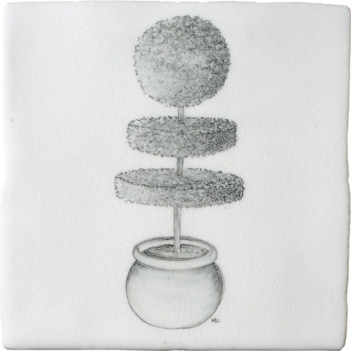 A cut out of an antique white square tile with topiary illustration in a charcoal style