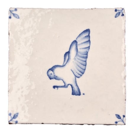 Cut out image of white tile with handpainted delft owl illustration and ornate corners