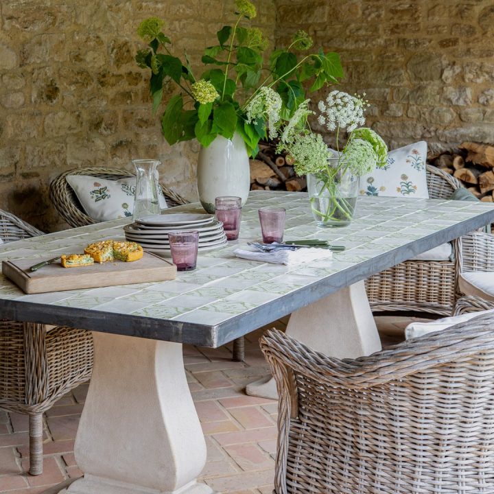 Outdoor seating area with a checkerboard Mediterranean tiled outdoor table