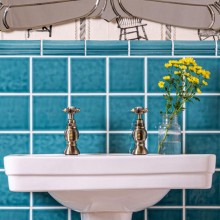 Chroma Romany Green teal wall tiles with matching bolection in a bathroom behind sink