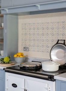 Handpainted Ana blue wall tiles behind the Aga range cooker