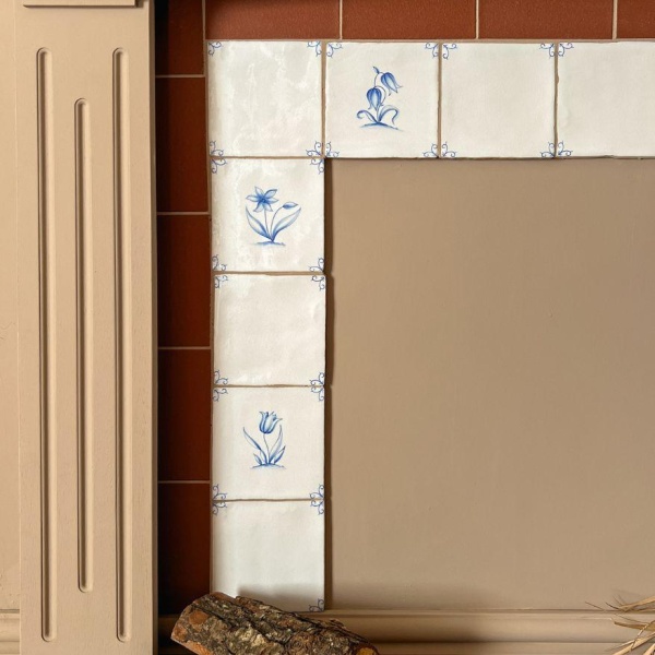 Close up of Classic Delft tiles in Rosalind on the fireplace of Callieanne of ourvictorianhome