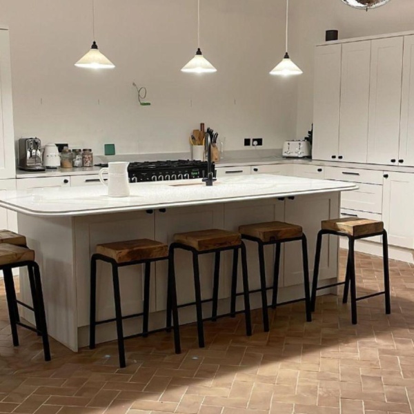 Herringbone designed terracotta effect Andalucia floor tiles in a bright customer kitchen