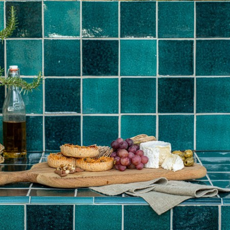 Isles Raasay square wall tiles in kitchen environment with cheeseboard and potted plant