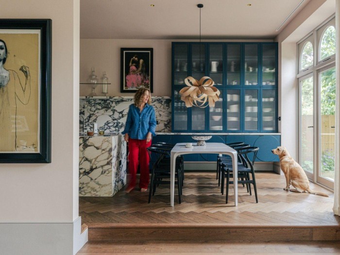 Tara and her dog in the dining area of her renovated home