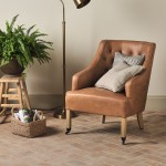 Andalucia Seville small brick porcelain floor tile laid in a herringbone pattern with rug, leather armchair and standing floor lamp