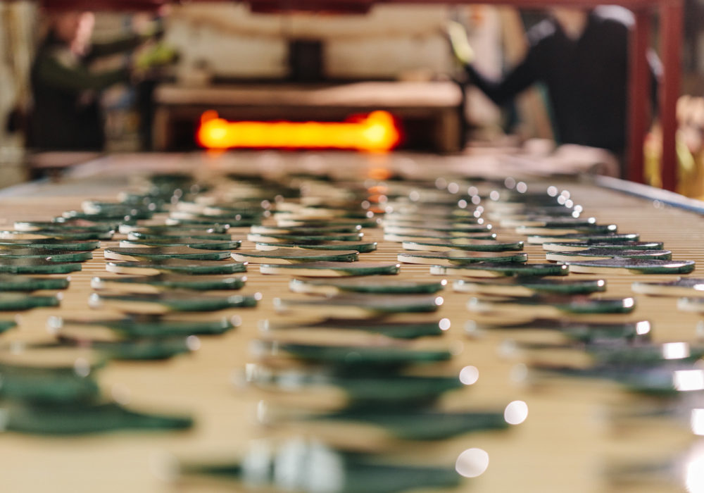 Green scallop tiles coming out from the kiln ready to be packaged