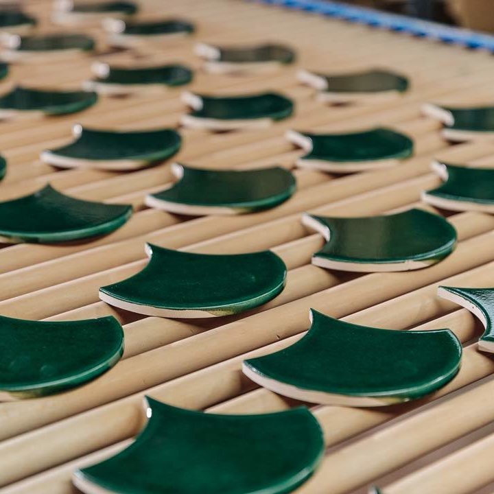 Green scallop tiles exiting the kiln