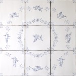 Cut out image of nine white tiles with blue delft illustrations of a cherubs and ornate floral corners