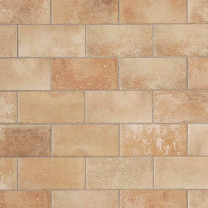 A flat lay image of pale terracotta Seville Small Brick tiles laid in a brick bond pattern and finished with Medium Grey grout