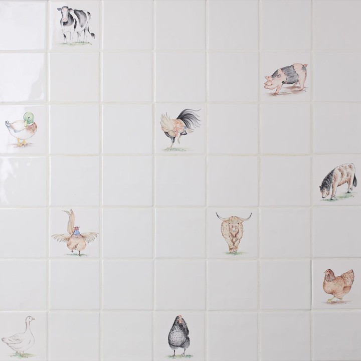 Wall of hand painted animal square tiles paired with plain tiles cockerels, highland cows, pigs and horses