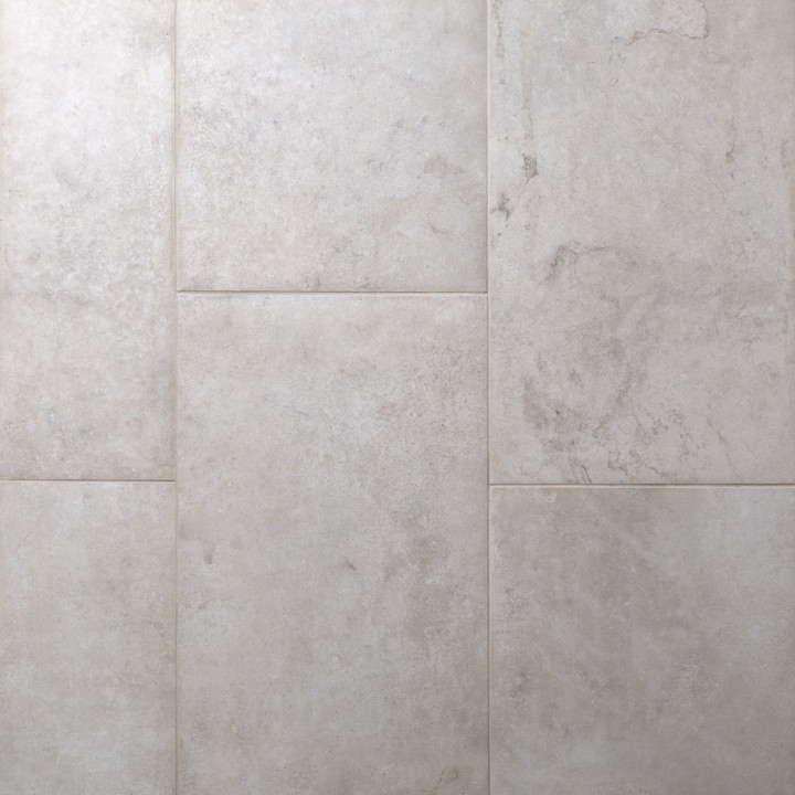 Floor of rectangle pale grey stone effect porcelain floor tiled with beige grout