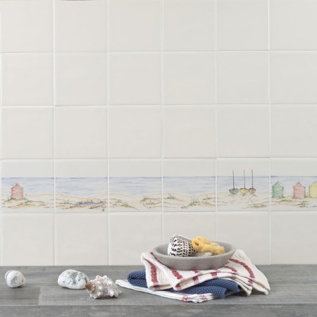 Wall of Hand painted bathroom beach square tile borders in a seaside style with sand and sea with beach huts and boats