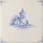 Cut out of a delft landscape and farm building square tile with the classic blue style with an ivory background and delft corners