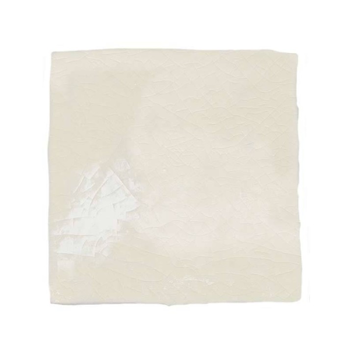 Cut out image of a cream crackle glazed taco tile