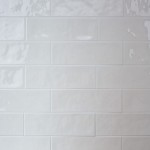 Wall of long white brick tiles with white grout