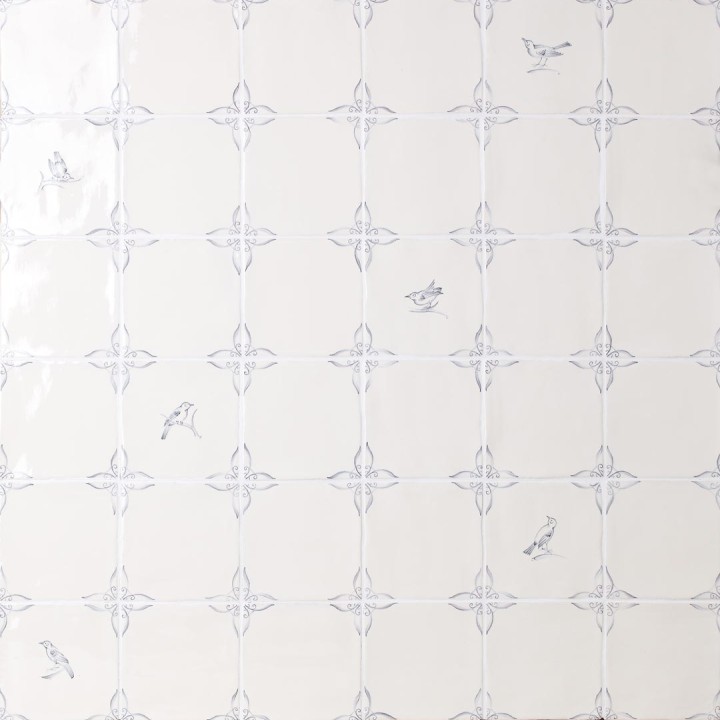 Wall of delft bird square tiles mixed with plain delft tiles in the classic blue style