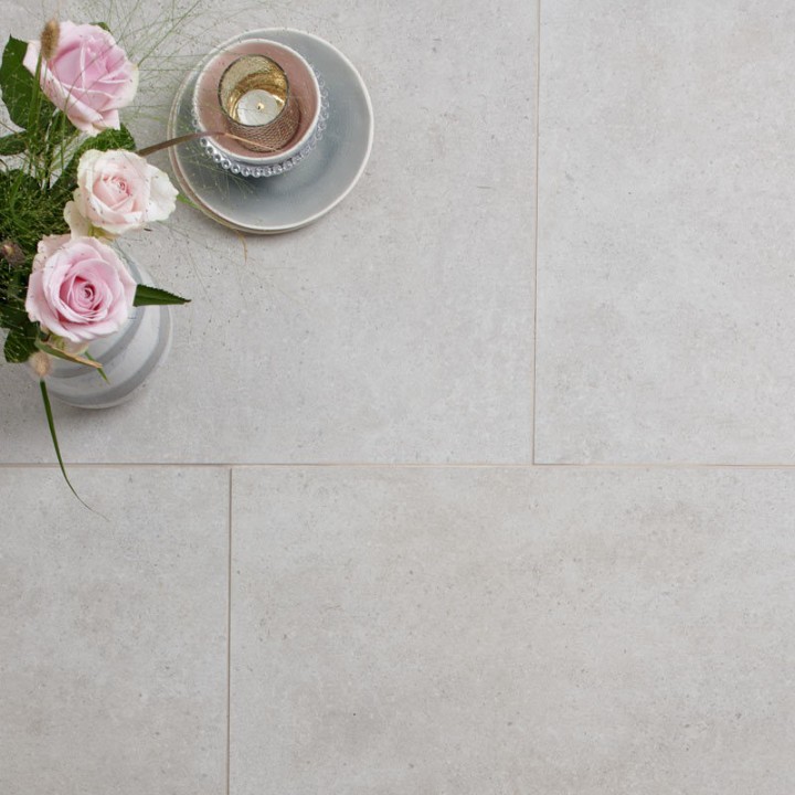 Dorset stone effect porcelain floor tile flat lay with a vase of pink roses and a coffee on top with beige grout