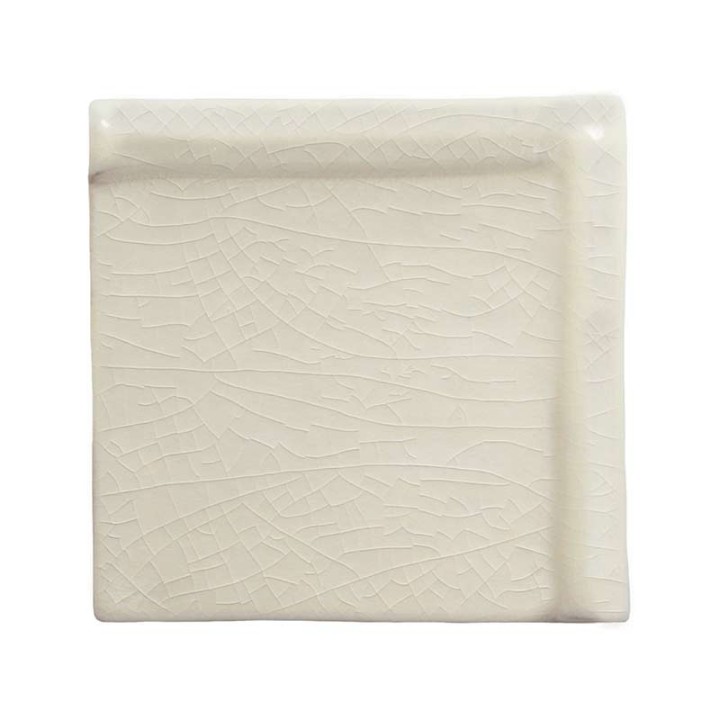 Cut out of border taco tile in off white with a gloss finish with a raised edge to use as a frame