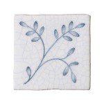 Cut out image of a taco crackle glazed tile with hand painted intricate leaf pattern in blue