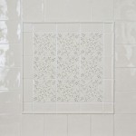 Wall of Emma Sage Green leaf Pattern Square tiles framed with half rounds and surrounded with Emma Sage Green Plain Square tiles