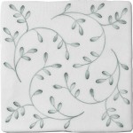 Cut out image of a crackle glazed tile with hand painted intricate leaf pattern in green