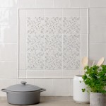 Flax Blue Pattern Square tiles wall panel, framed with half rounds and paired with Emma Flax Blue Plain Square tiles and border tiles behind a kitchen worktop