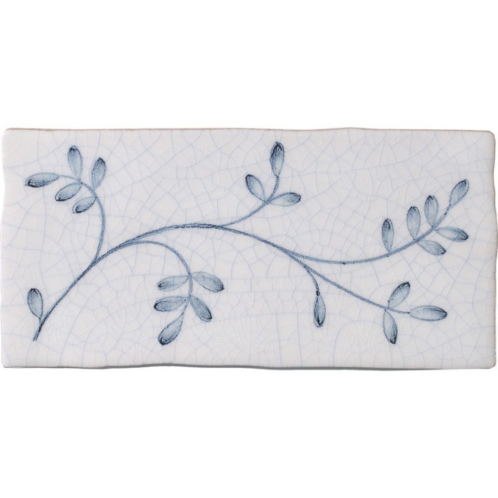 Cut out image of a brick crackle glazed tile with hand painted intricate leaf pattern in blue