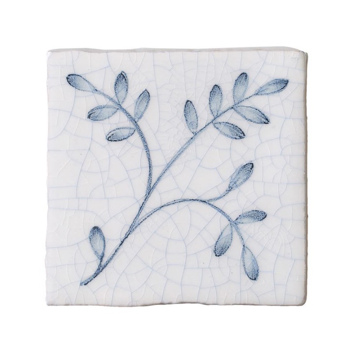 Cut out image of a taco crackle glazed tile with hand painted intricate leaf pattern in blue