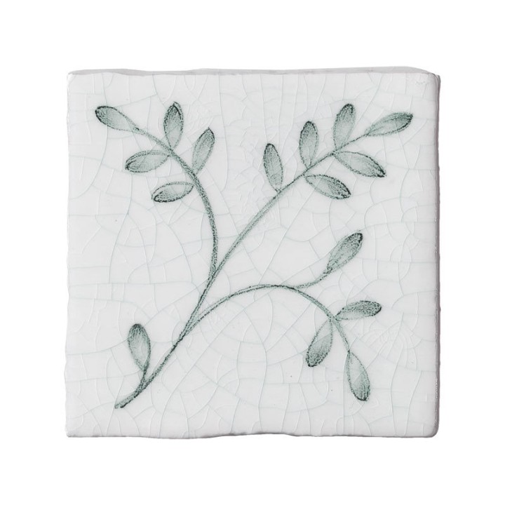 Cut out image of a crackle glazed taco tile with hand painted intricate leaf pattern in green
