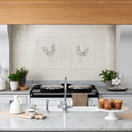 Tiled Cooker splashback of two 6 tile panels of two cockerels facing each other framed with tiled borders above an aga