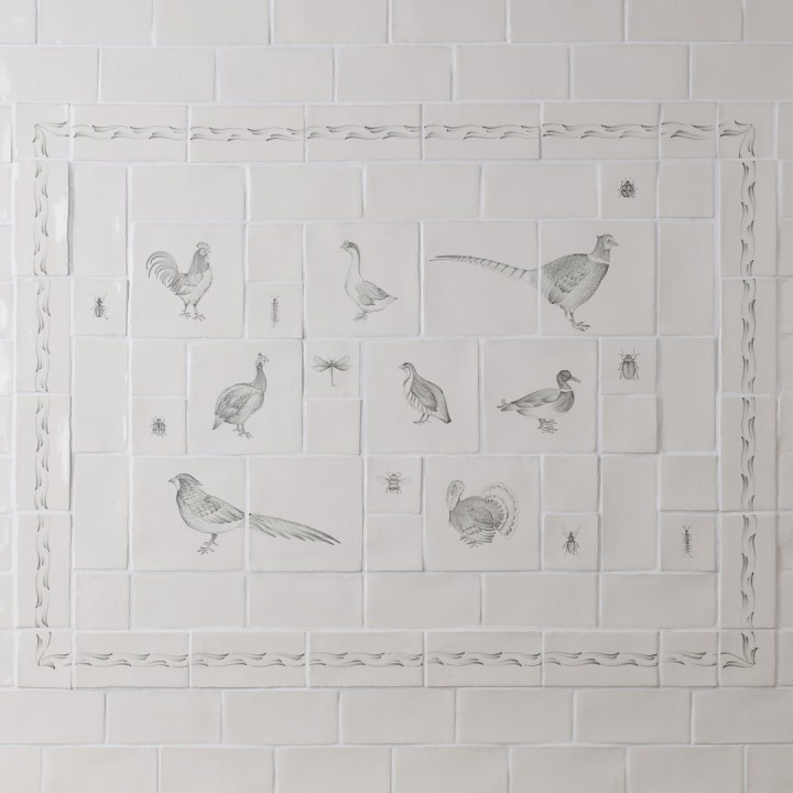 Cooker splash back tile panel with country birds and insects with a border framed with antique white square tile