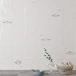 Wall of antique white tiles and fish tiles hand painted with fish motifs with white grout
