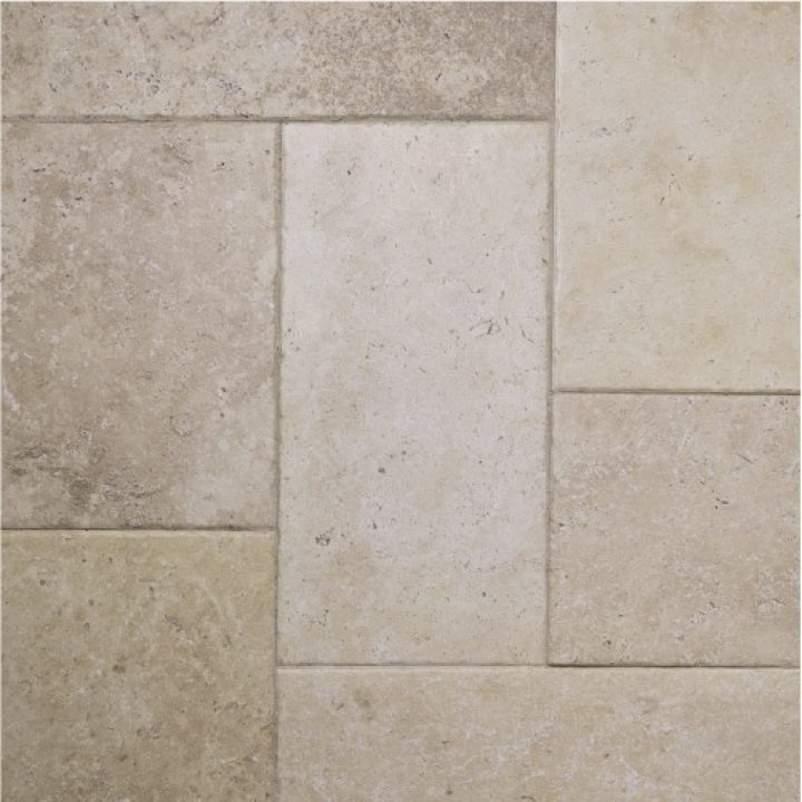 Combined layout of french limestone floor tiles in a formation of squares and rectangles.