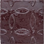Cut out of artisan rustic burgundy square tile with flower pattern piped on top