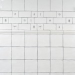 Wall of antique white square tiles with insect taco tiles and metro tiles