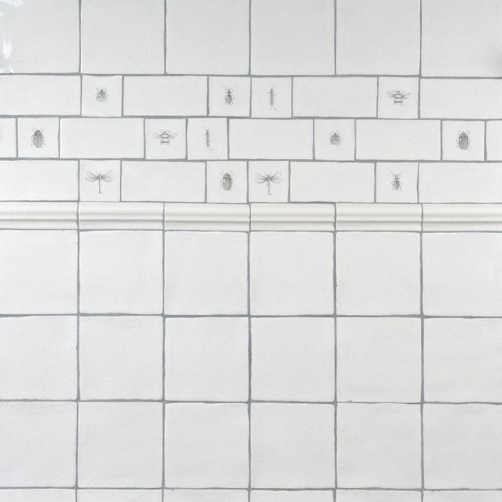 Wall of antique white square tiles with insect taco tiles and metro tiles