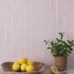 Wall of skinny blossom tiles with white grout behind a fruit bowl and house plant