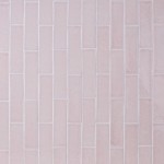 Wall of skinny pale grey tiles with white grout laid in a vertical brick bond pattern