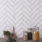 Wall of skinny warm white tiles with limestone grout behind kitchen accessories