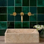 Compilation of different shades of green square tiles behind a rectangle sandstone basin and gold taps