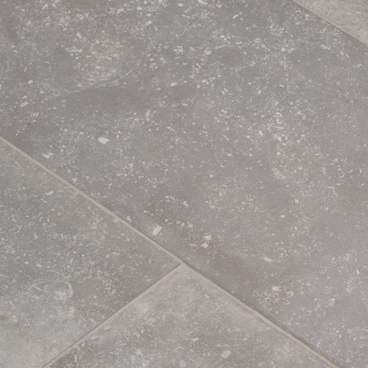 Close up of floor of grey stone effect porcelain floor tile with grey grout from an angle