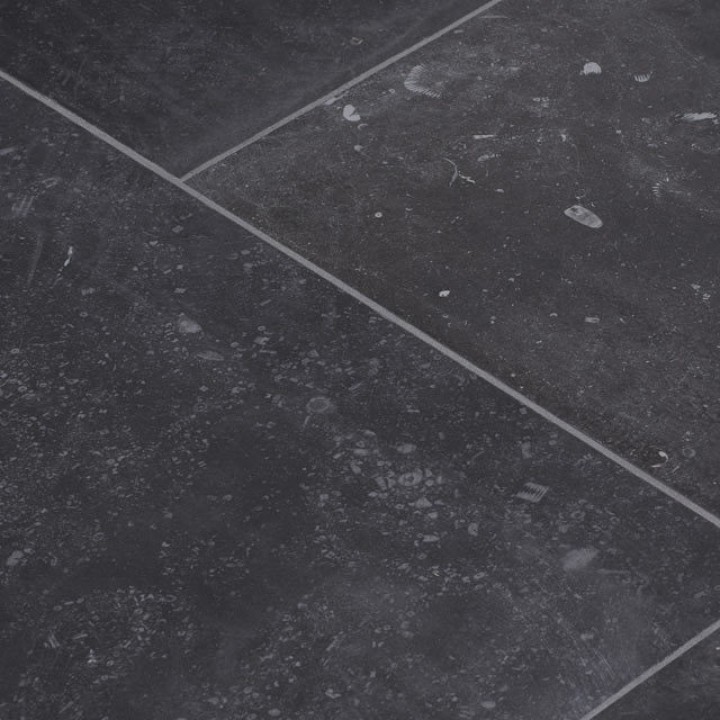 Floor of dark charcoal grey stone effect rectangle porcelain floor tile close up at an angle to show the texture