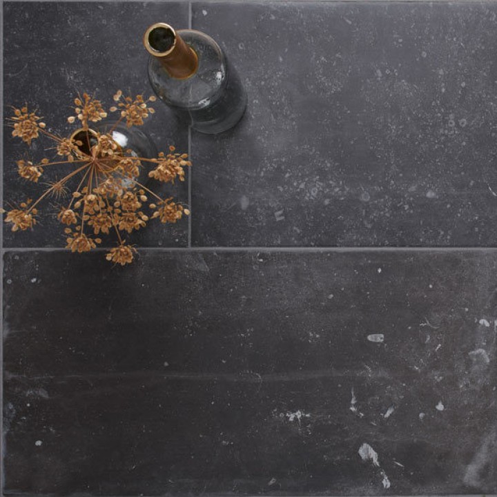 Floor of dark charcoal grey stone effect porcelain floor tile with Medium Grey grout with vase on top